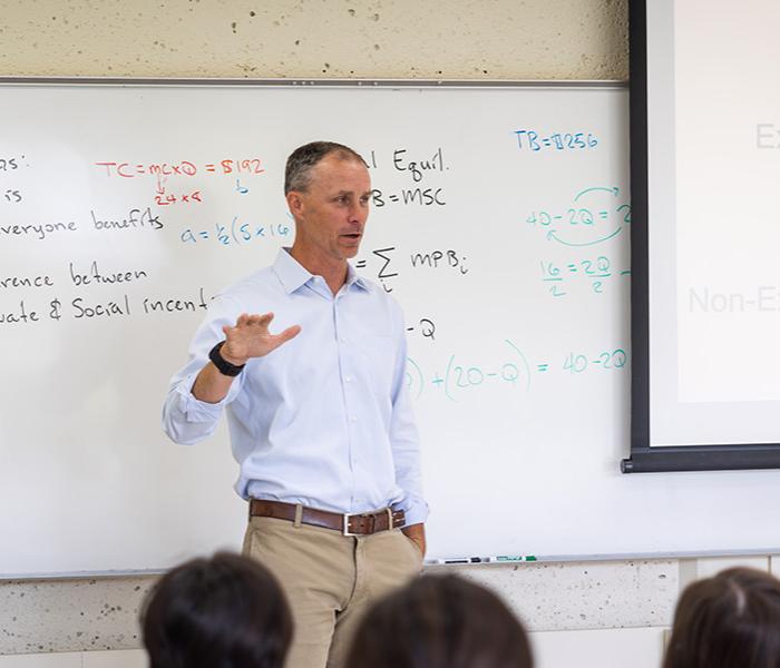 professor lectures in front of a class