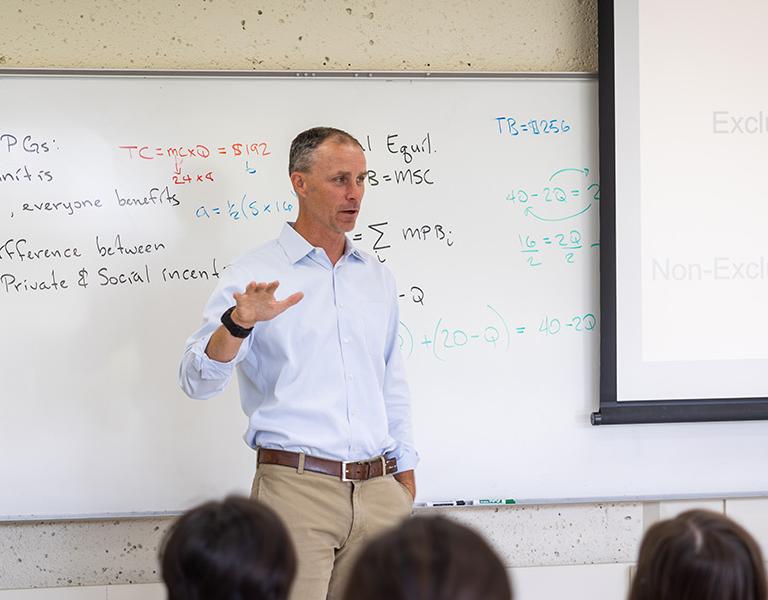 professor lectures in front of a class